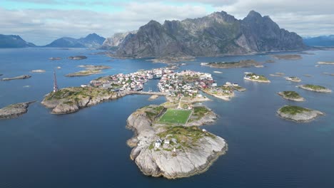 henningsvaer village and soccer field in lofoten island archipelago, norway - 4k aerial circling