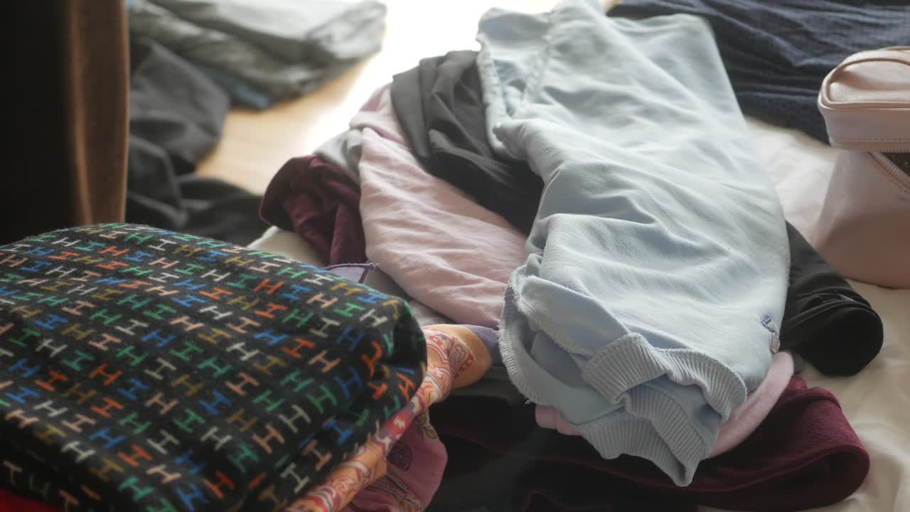 беспорядочная куча одежды на постели