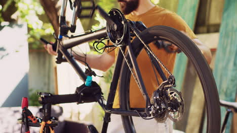 skillful man mending bicycle crank arm