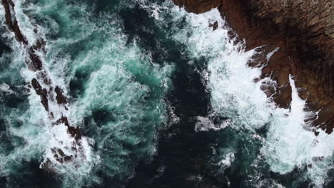 Coastal-Waves-Creating-Mesmerizing-Oceanic-Textures,-Aerial-spinning-Top-Down-View