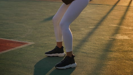 woman doing squats outdoors