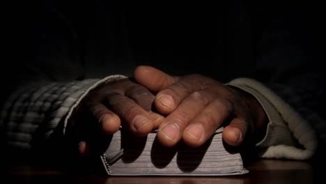 black man praying and reading the bible on a table top stock video stock footage