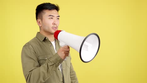 asian man shouting into a megaphone