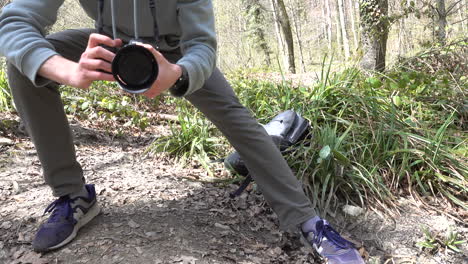 a young filmmaker makes a subtle sideways camera movement, supporting himself with his legs