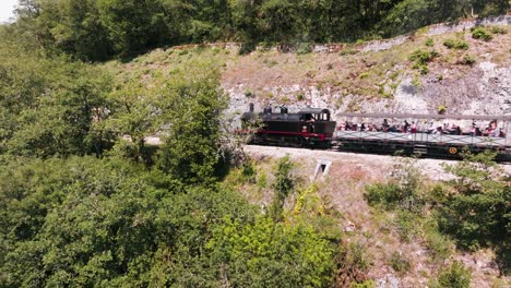 drone tracking of a steam train on the edge of a cliff, martel, lot, france