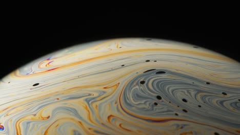 surface with grey and yellow line streaks creating a swirly motion