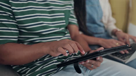 hands, tablet and couple on a sofa in the living