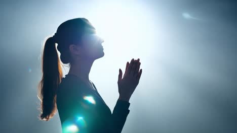 woman praying with hands together