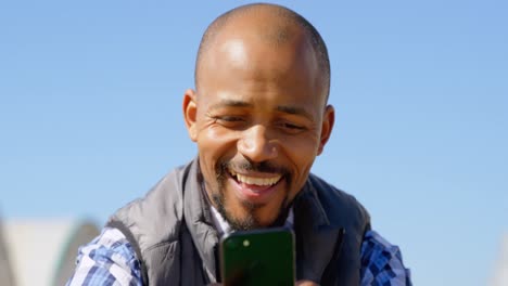 man using mobile phone in blueberry farm 4k