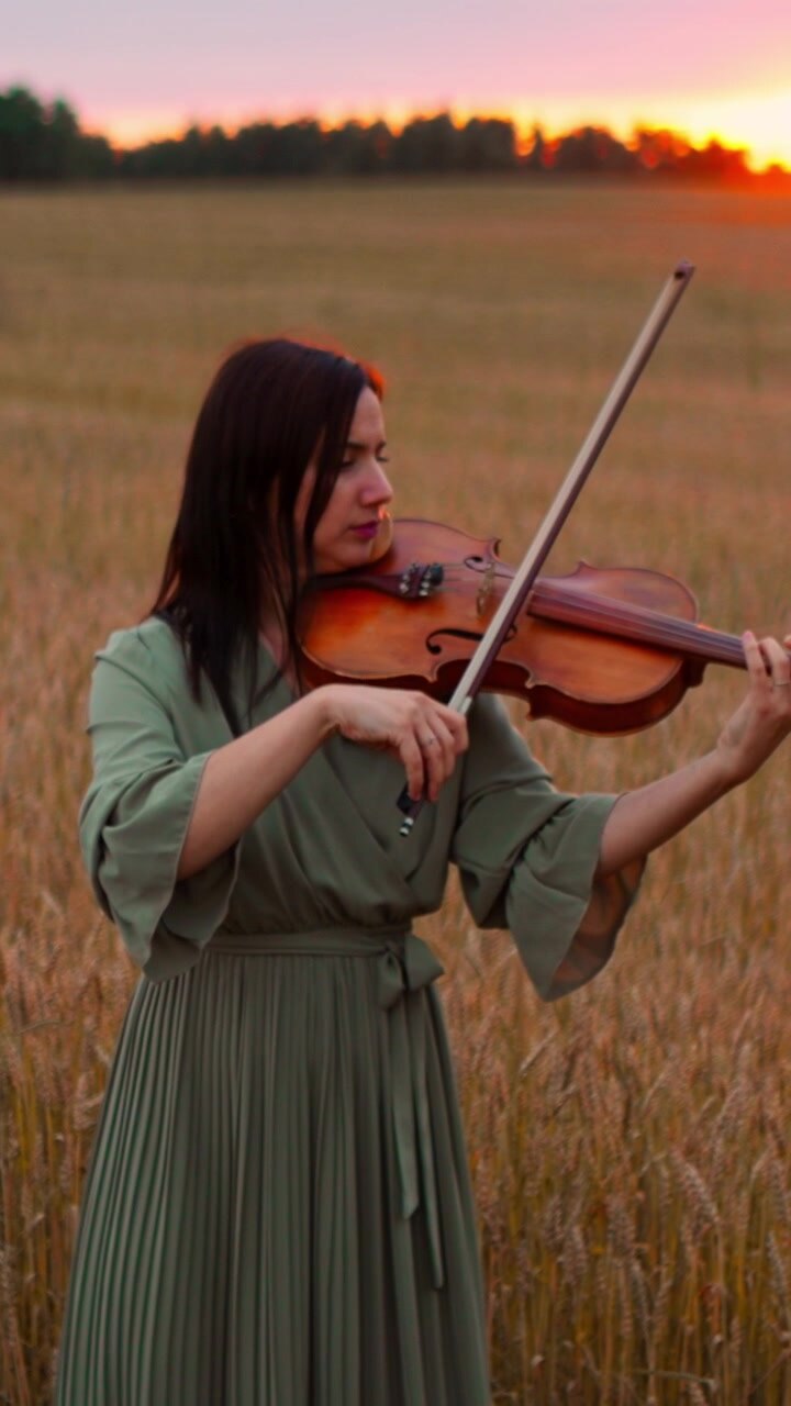 Woman Playing Violin in a Wheat Field at Sunset