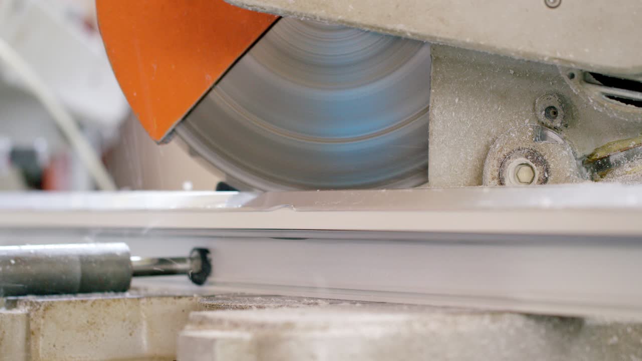 Grinder cutting a PVC profile panel