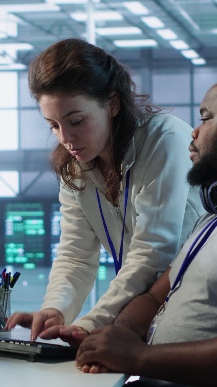 Diverse Team of IT Engineers Collaborating on Computer in Data Center