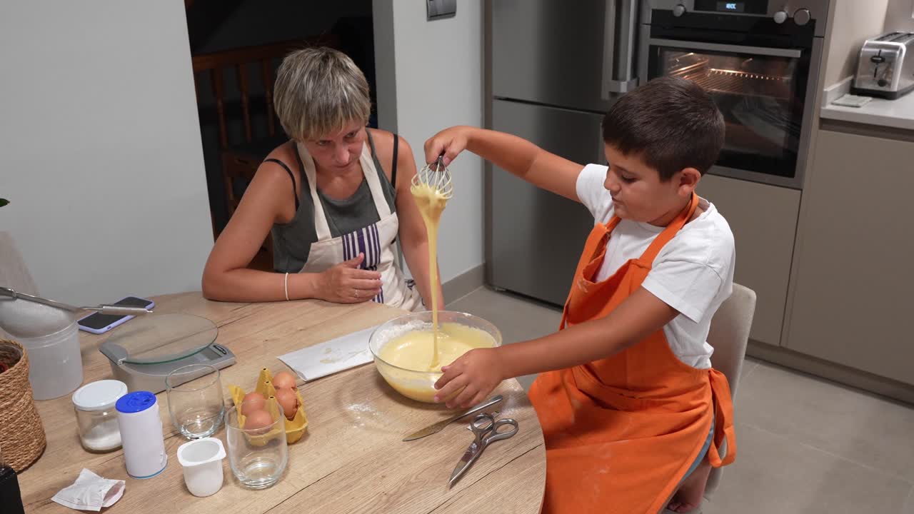 Woman and boy baking in the kitchen