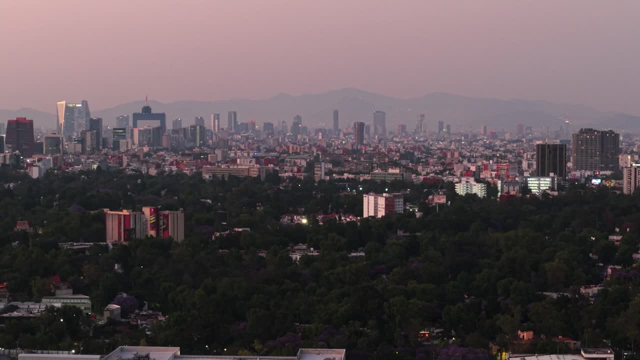 Reddish sunset over the contaminated Mexico City, from a drone's perspective.
