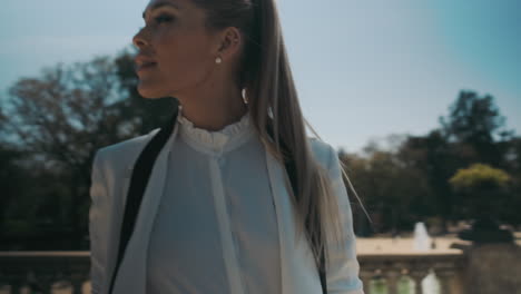 stylish young woman standing outdoors.