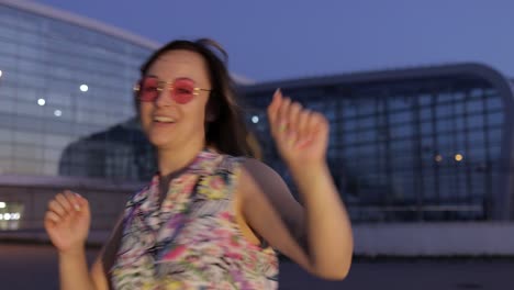 happy woman tourist dancing, having fun, enjoying dance, celebrating success, party music. evening