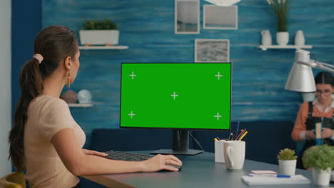 Caucasian-woman-working-on-mock-up-computer-green-screen