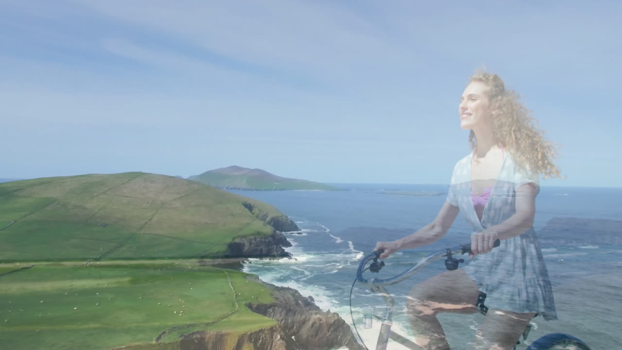 Riding bicycle, woman enjoying scenic coastal landscape with ocean and green hills