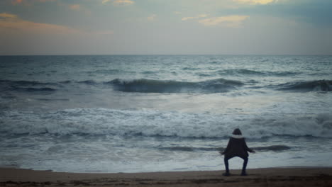 dancing boy on ocean shore