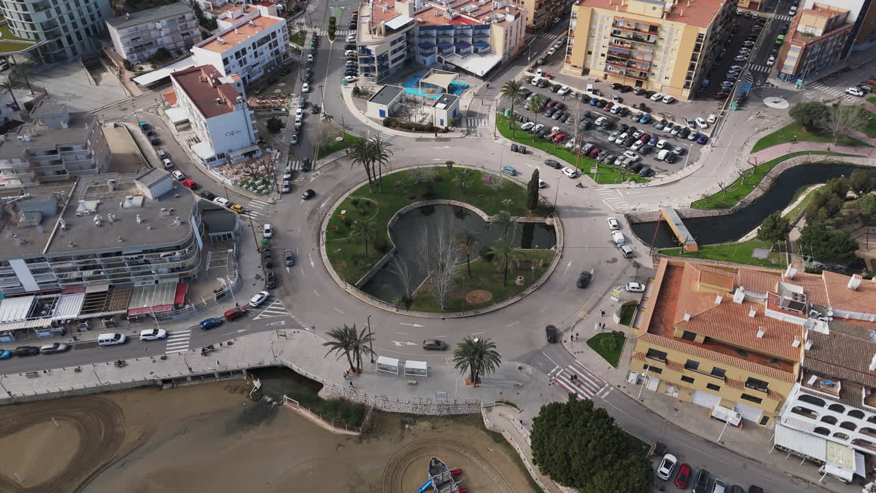 Aerial topdown of Placa Constitució roundabout with cars and buildings near Playa Sur