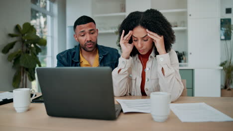 Stressed couple dealing with financial problems at home
