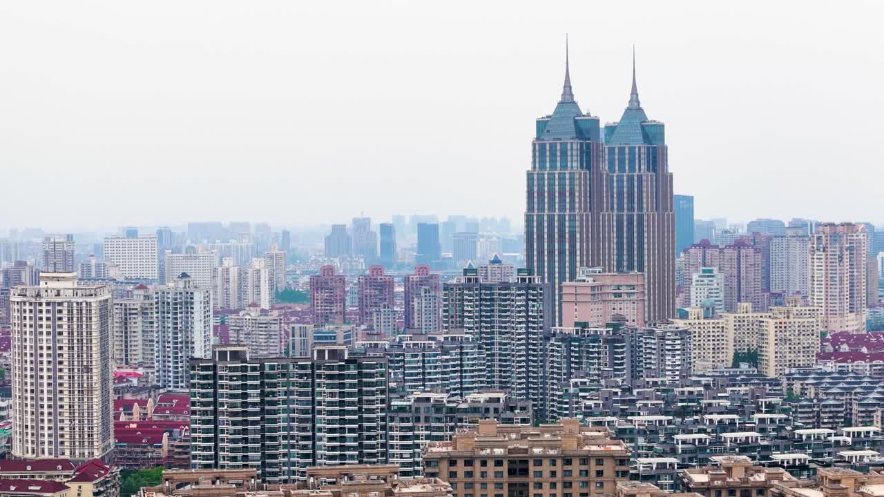 Slow orbiting drone shot of Skyscraper buildings, river, and cityscape during a hazy day in Shanghai, China