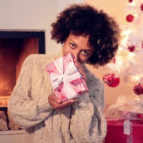 close up of beautiful black woman holding present