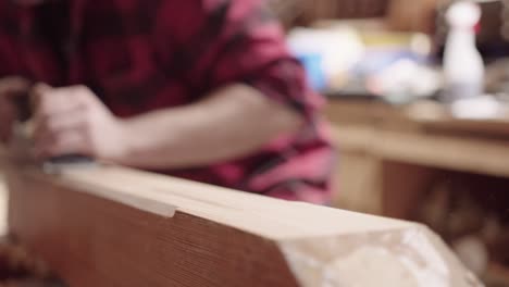 close up of carpenter woodworking with planes and clamps