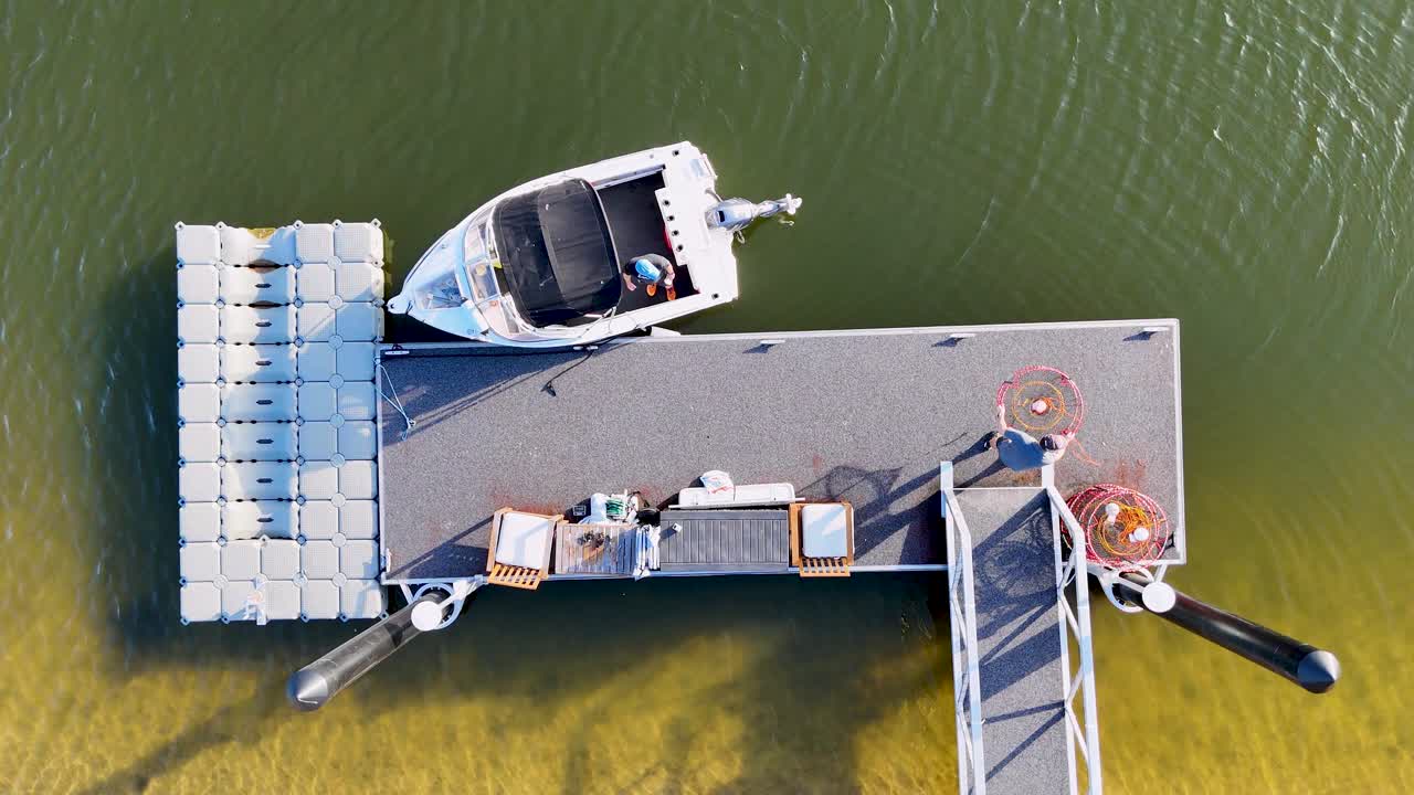 Boat docked at pontoon with crab traps