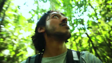 Man-walking-through-tropical-rainforest-in-Ecuador