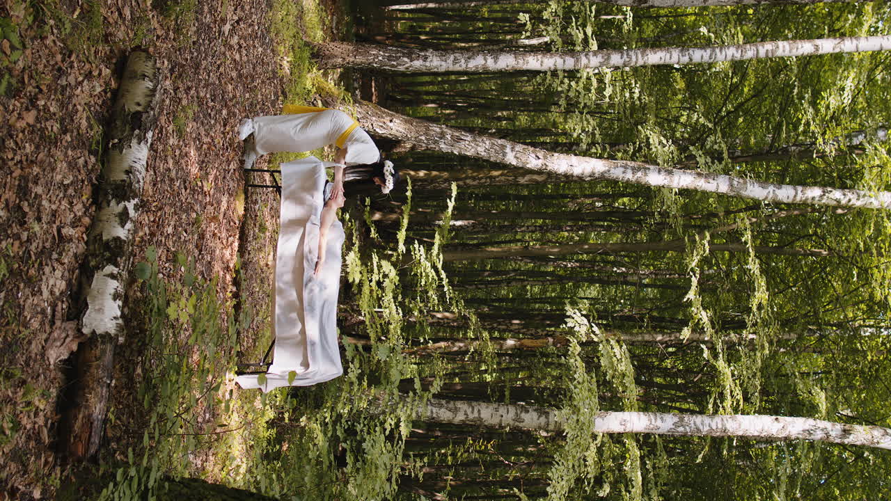 Therapist female doctor making woman relaxing spa face massage with hands outdoors in the forest