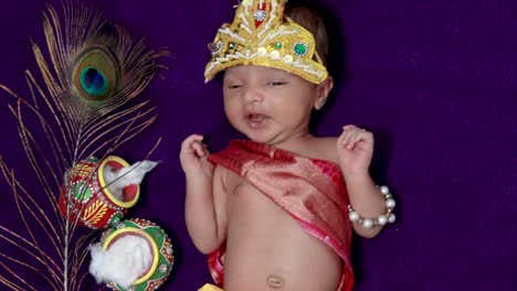 newborn-baby-boy-in-krishna-dressed-with-props-from-unique-perspective-in-different-expression