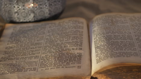 mysterious historic book lies open on table, close up shot