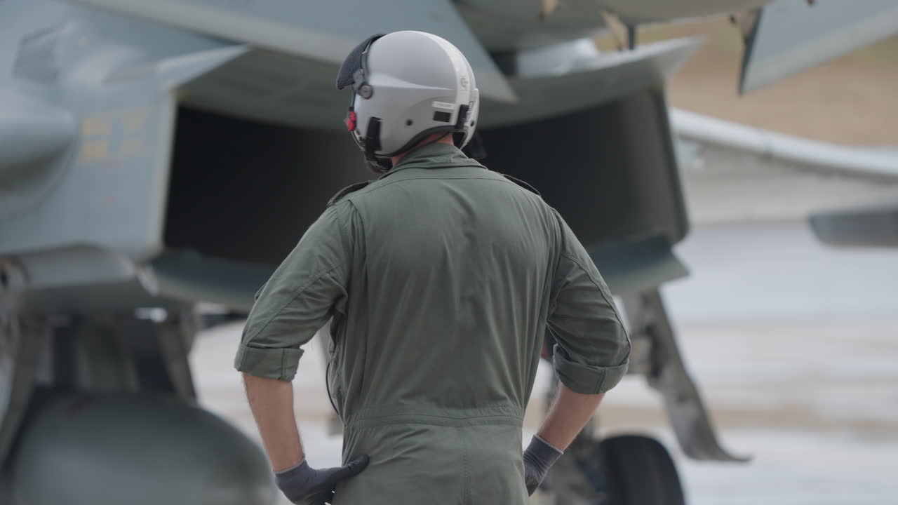 Pilot standing in front of fighter jet