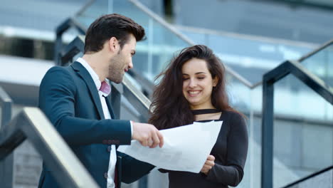 closeup couple celebrating victory. business partners discussing documents