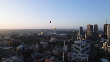 hot air balloons over melbourne city at sunrise