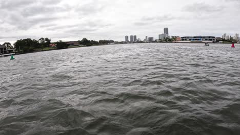 river with city skyline and cloudy sky