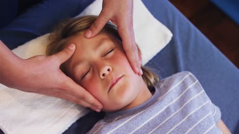 physiotherapist giving head massage to a boy 4k