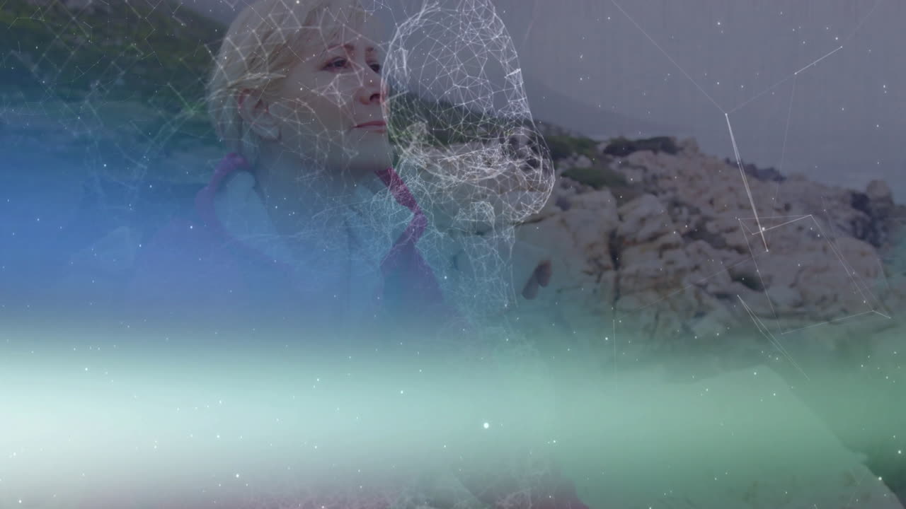 female hiker meditating on mountain peak, with wireframe overlay showing health data