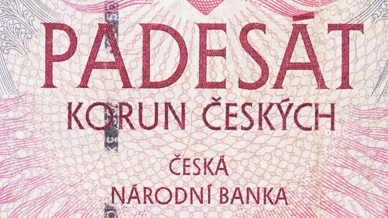 Tilt macro reveal of Czech National Bank text on a Czech koruna note