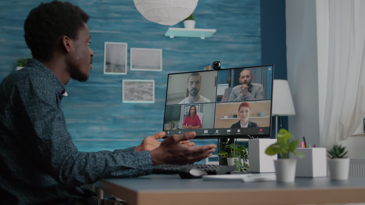 Man of african ethnicity using online conference webcam communication