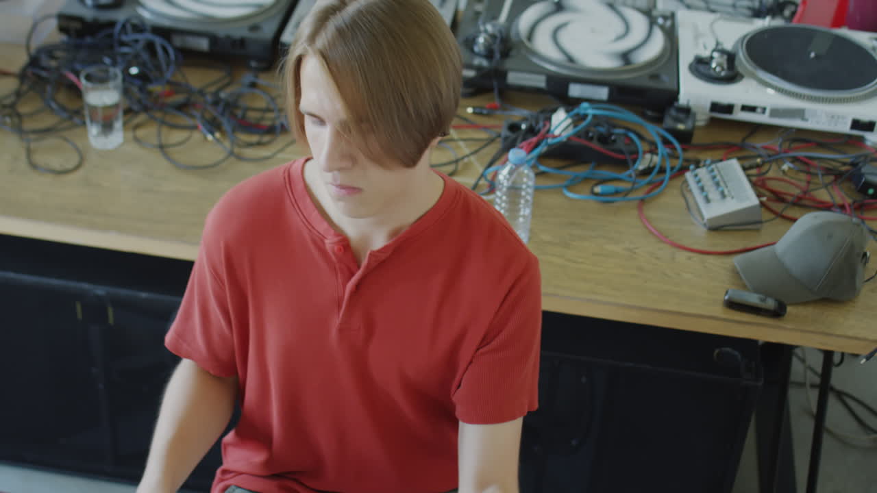 Young man playing drums in a studio setting