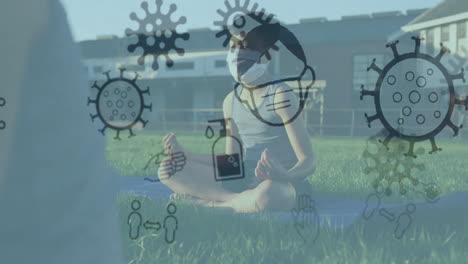 múltiples iconos de concepto de covid-19 flotando contra un niño que usa practicando yoga en el jardín de la escuela