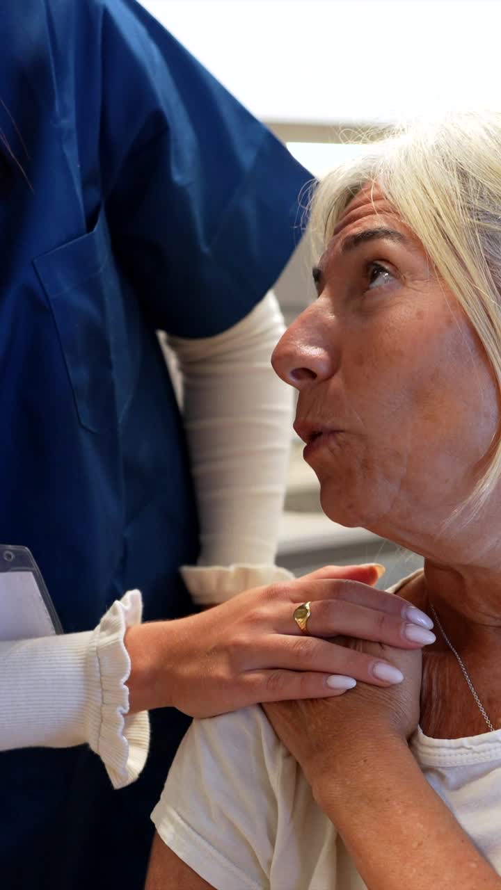 Caring Nurse Comforting Senior Woman