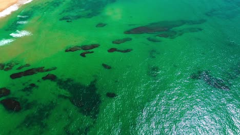 aerial-view-of-ocean,-crushing-waves,coral-reef-and-beach,-4k