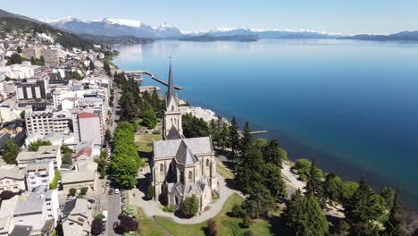 aerial - cathedral next to nahuel huapi lake, bariloche, rio negro, argentina, rising reverse