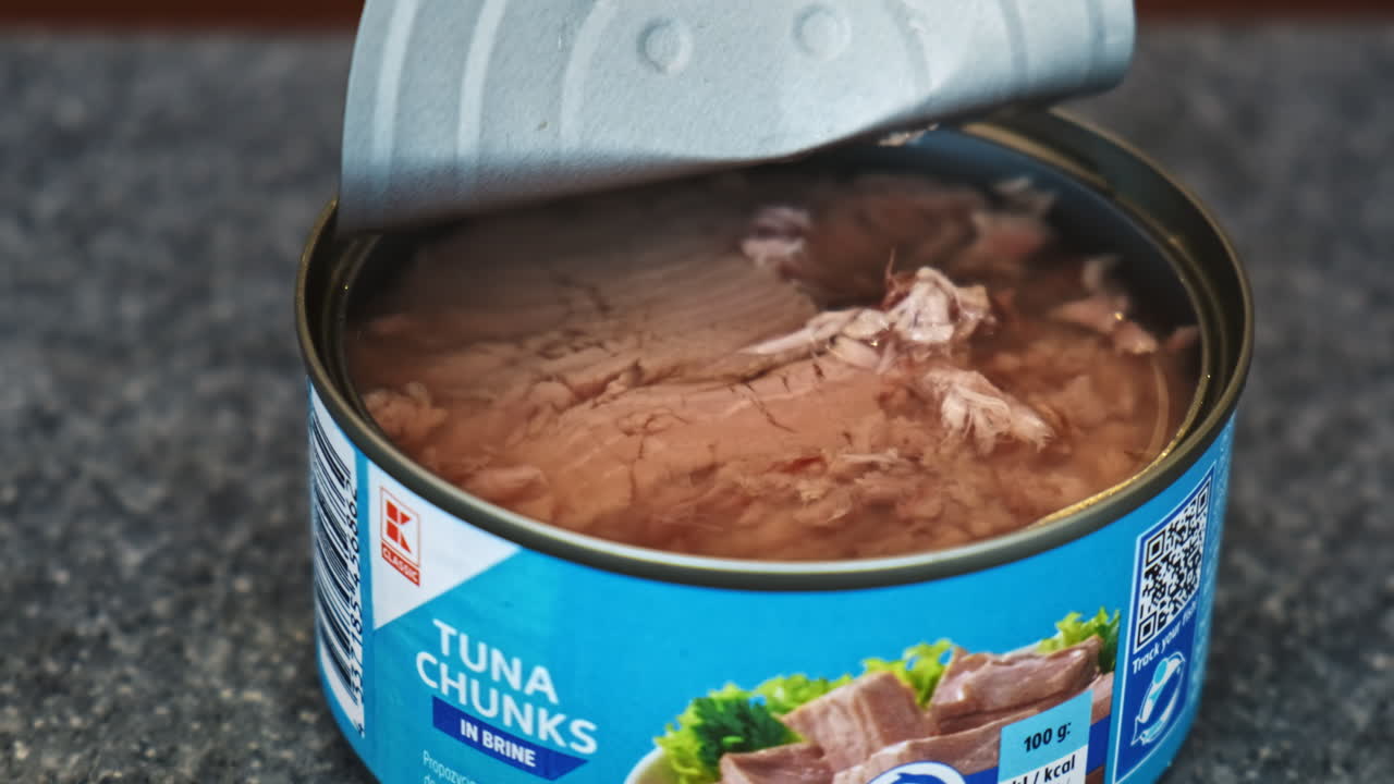 CHISINAU, MOLDOVA - JANUARY 6, 2020: Opened can with tuna chunks on a kitchen table
