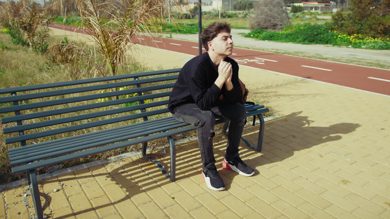 Angry And Stressed Man On The Park Bench During The Day
