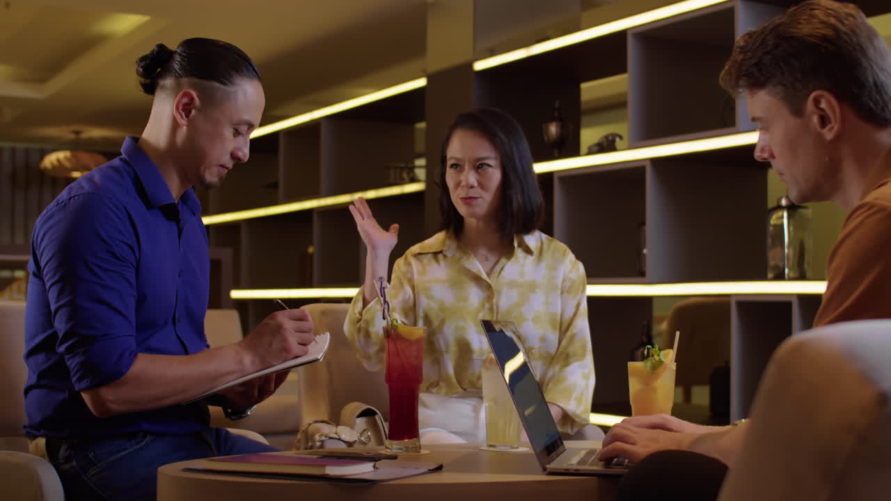 Businesswoman Mentoring Two Male Entrepreneurs in Workspace