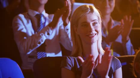 Caucasian-businesswoman-applauding-in-business-seminar-at-auditorium-4k